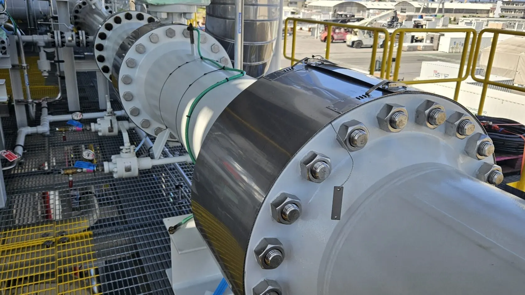 Coated heat exchanger and pipework on a plant module, among gratings and painted steelwork